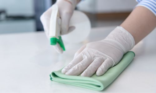 A person cleaning a table