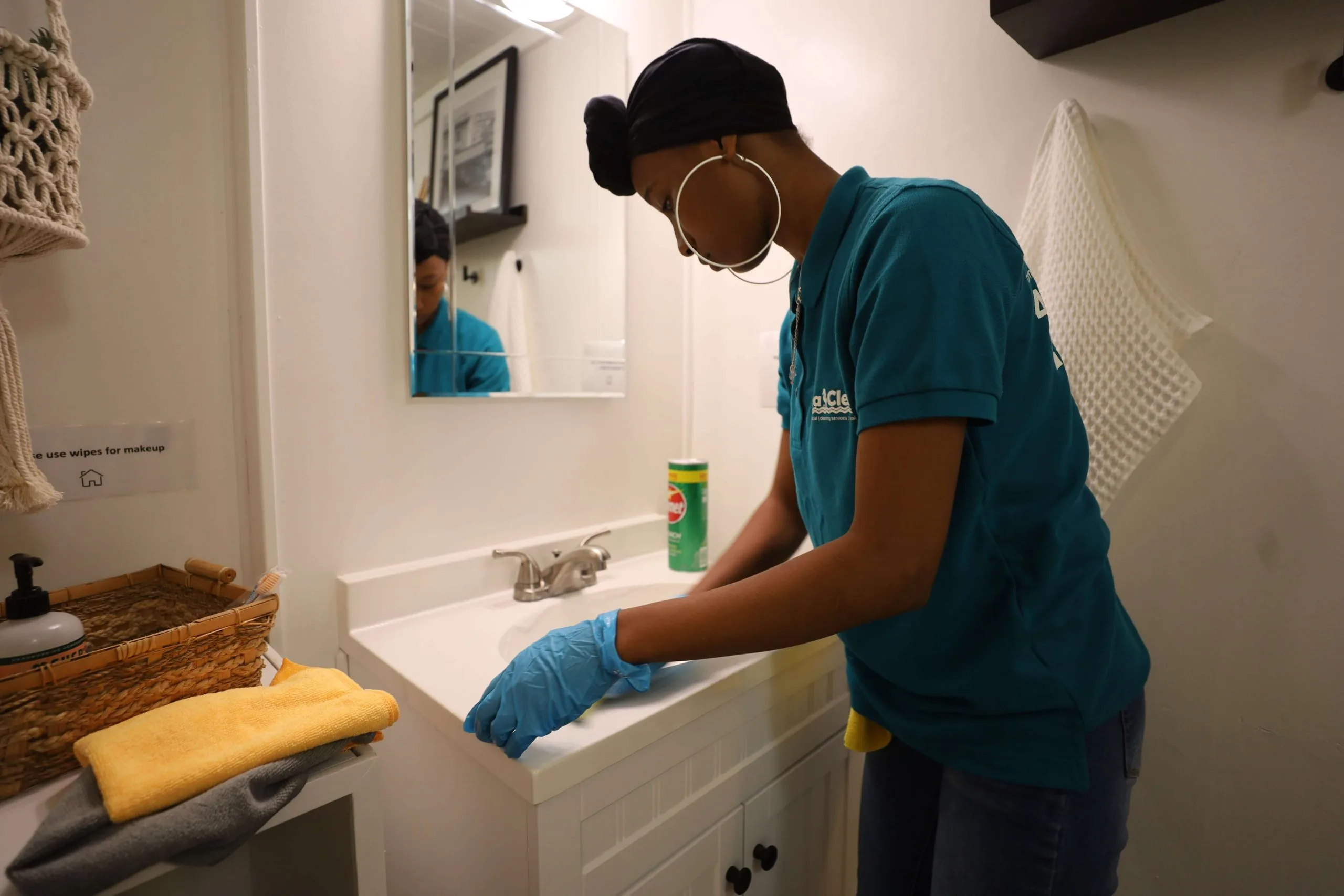 A woman washing a sink