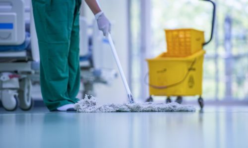 A person cleaning a hospital