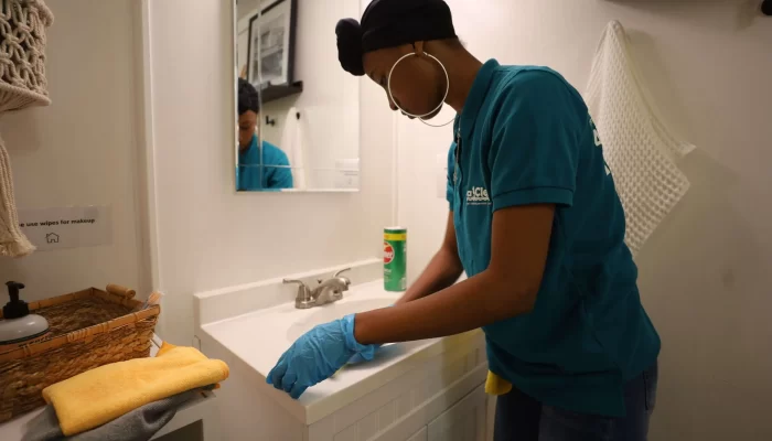 A woman washing a sink